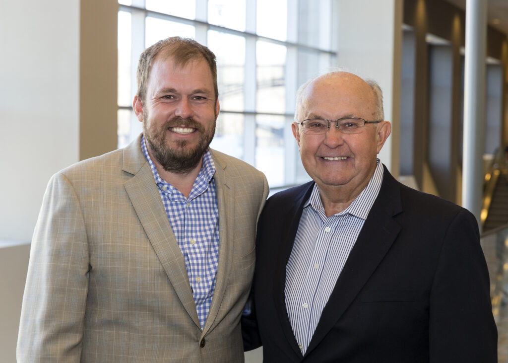 Two Fischer Group associates smiling together at the annual company meeting in Lawrenceburg, Indiana.